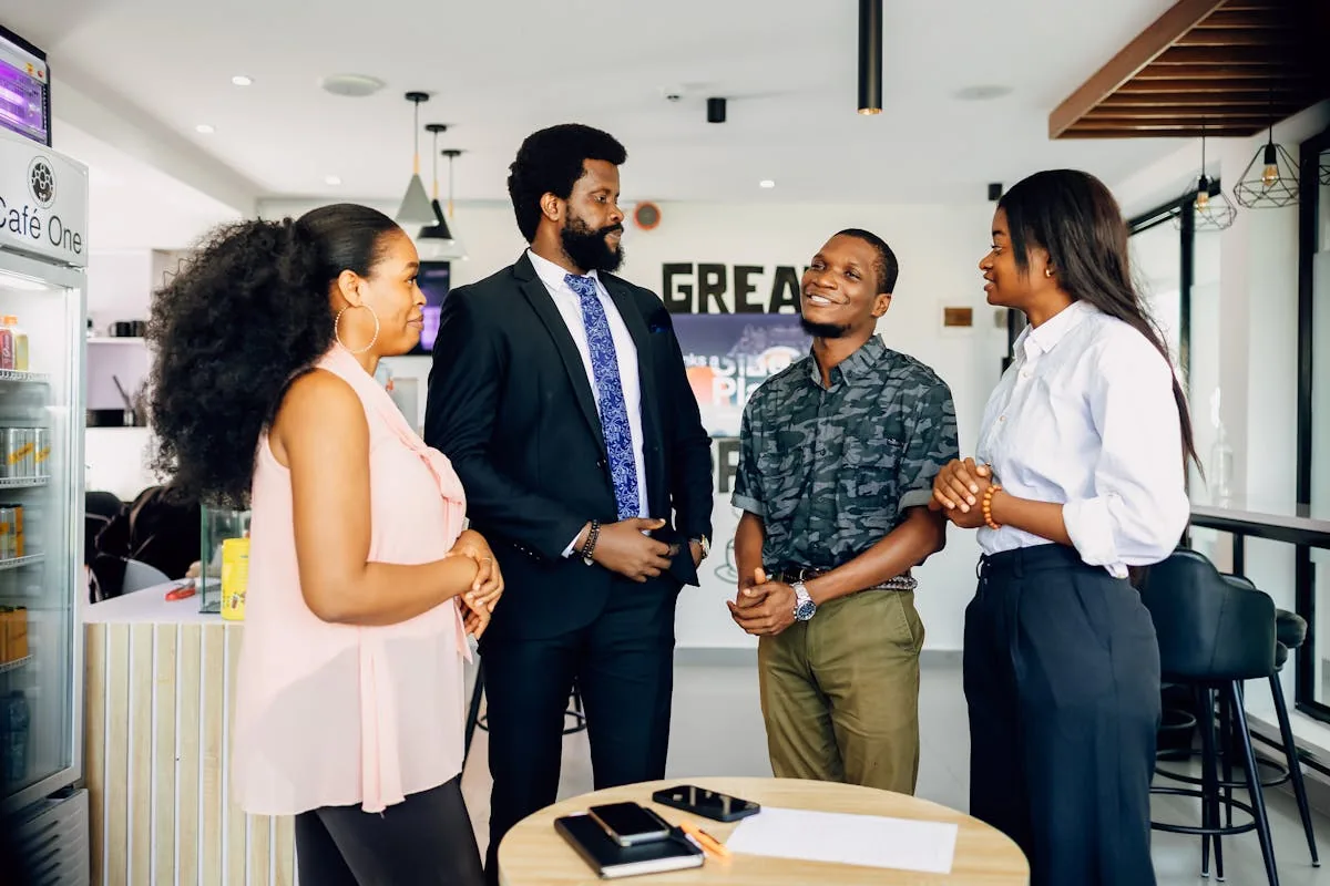 A team of African business professionals in discussion at a modern Softserve workspace
